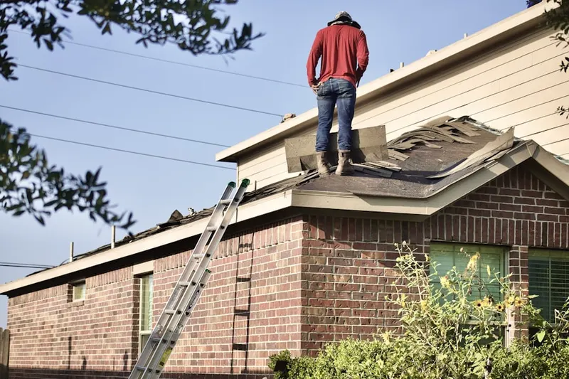 Professional roofer working on a residential roof in North Valley View